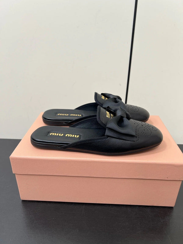 BOW MULES IN BLACK SHEEPSKIN