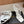 ALAIA THREE-STRAPS HIGH HEEL SANDALS IN WHITE PATENT LAMBSKIN