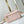 POCHETTE MÉTIS EAST WEST 21 IN PINK OPALE MONOGRAM ECLIPSE CANVAS GOLD BUCKLE