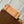 CARRYALL PM 29 IN CIDER BROWN MONOGRAM PERFORATED SUEDE AND WHITE SHEARLING TRIM