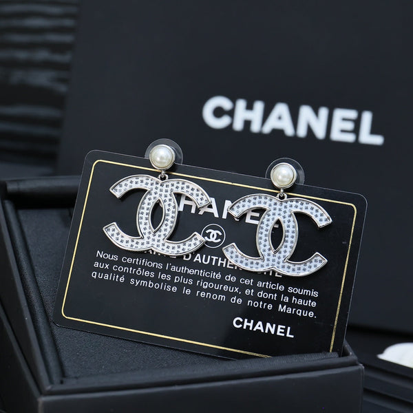 DOUBLE C EARRINGS IN SILVER METAL WITH BLACK SNOWFLAKE EMBOSSED ON WHITE ENAMEL