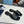 PRA SAFFIANO PATENT SLIDES OSTRICH MOTIF BLACK CALFSKIN