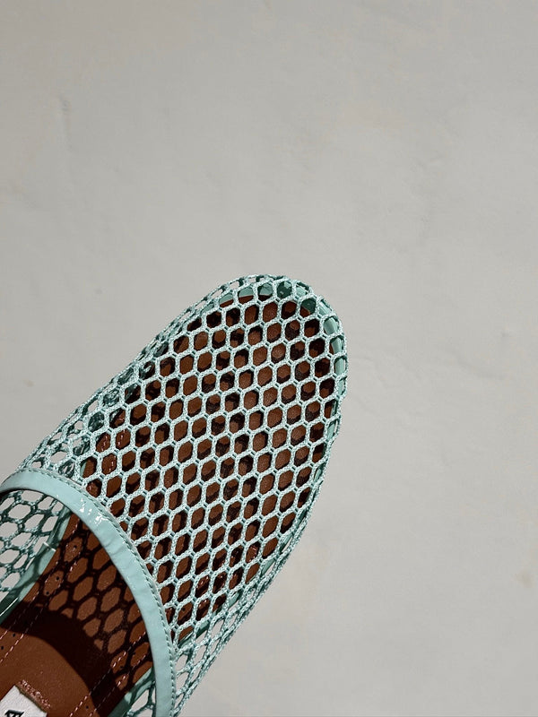 ALAIA FLAT MULES IN LIGHT BLUE MESH FISHNET