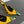 GREEN GEM-STUDDED SLINGBACK PUMPS IN YELLOW PATENT CALFSKIN