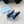 BALLERINA PUMPS WITH TRIANGLE LOGO AND BOW IN BLACK CALFSKIN