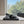 CRYSTAL BUCKLE BLACK WAX-OIL SHEEPSKIN HEELED MULES